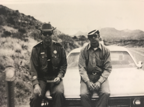 Sheriff Rick Thompson sitting on hood of a squad car
